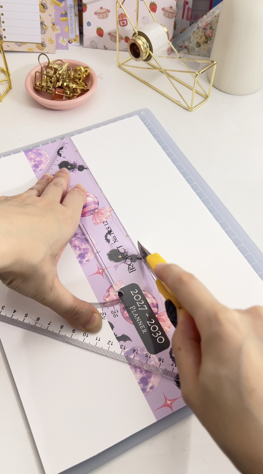 Trimming and folding the printed cover sheets with a bone folder