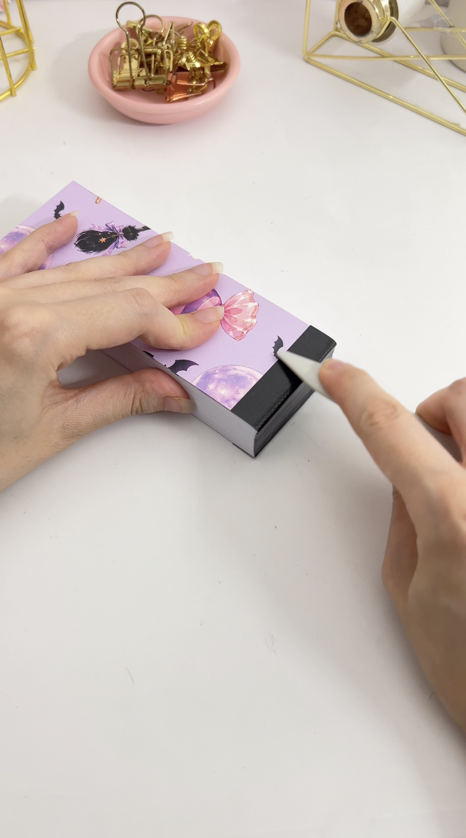 Burnishing the cloth tape into the join between spine and cover with a bone folder
