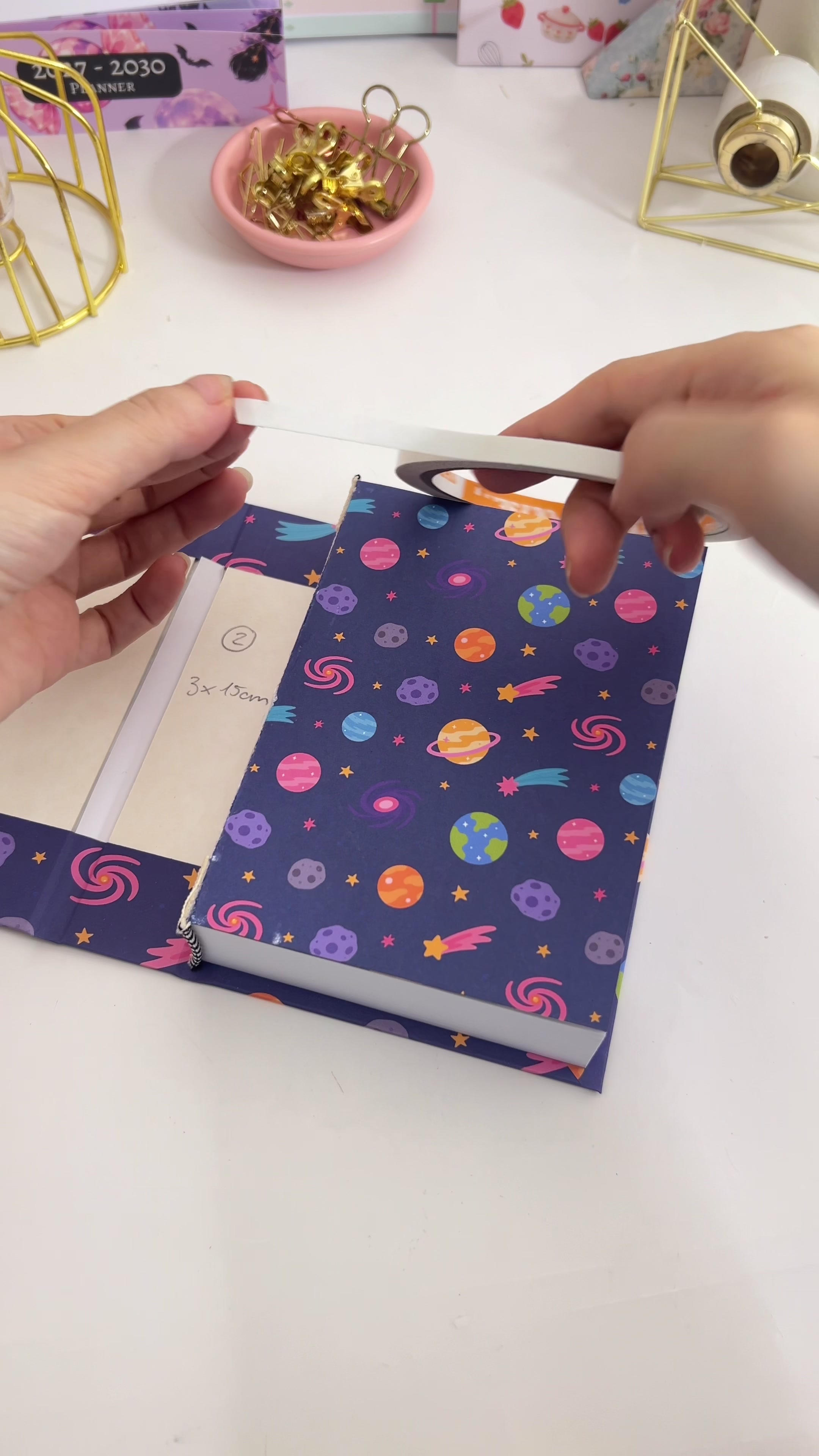 Applying double-sided tape to the endpaper of the book block