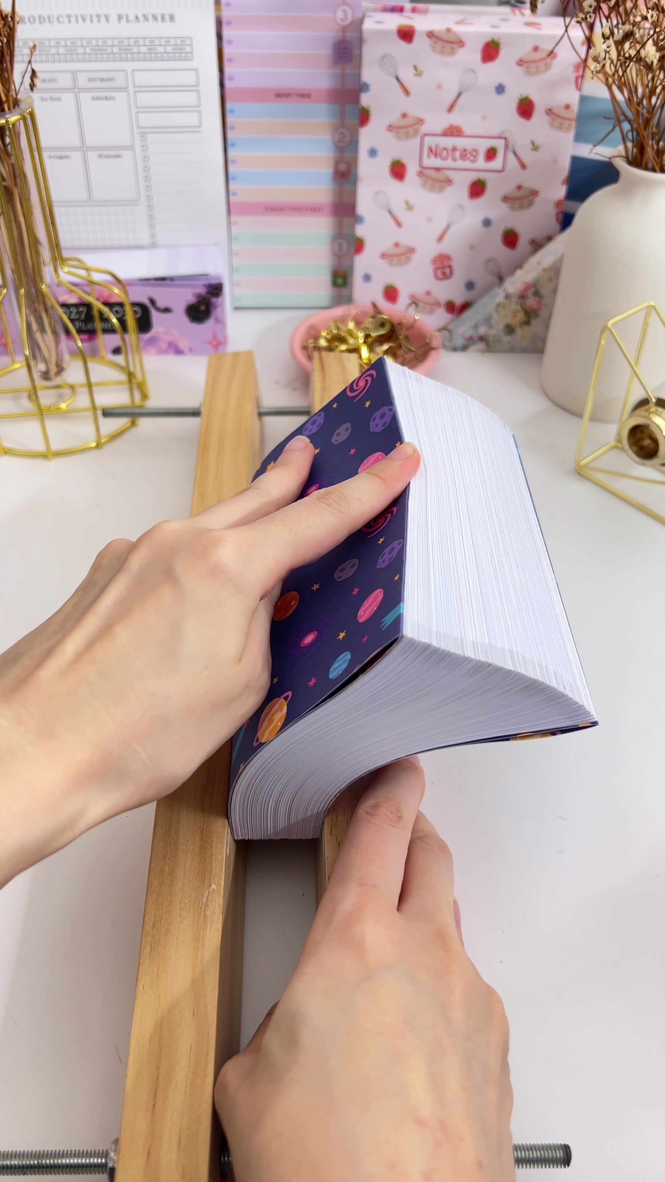 Applying PVA glue along the spine of the clamped text block