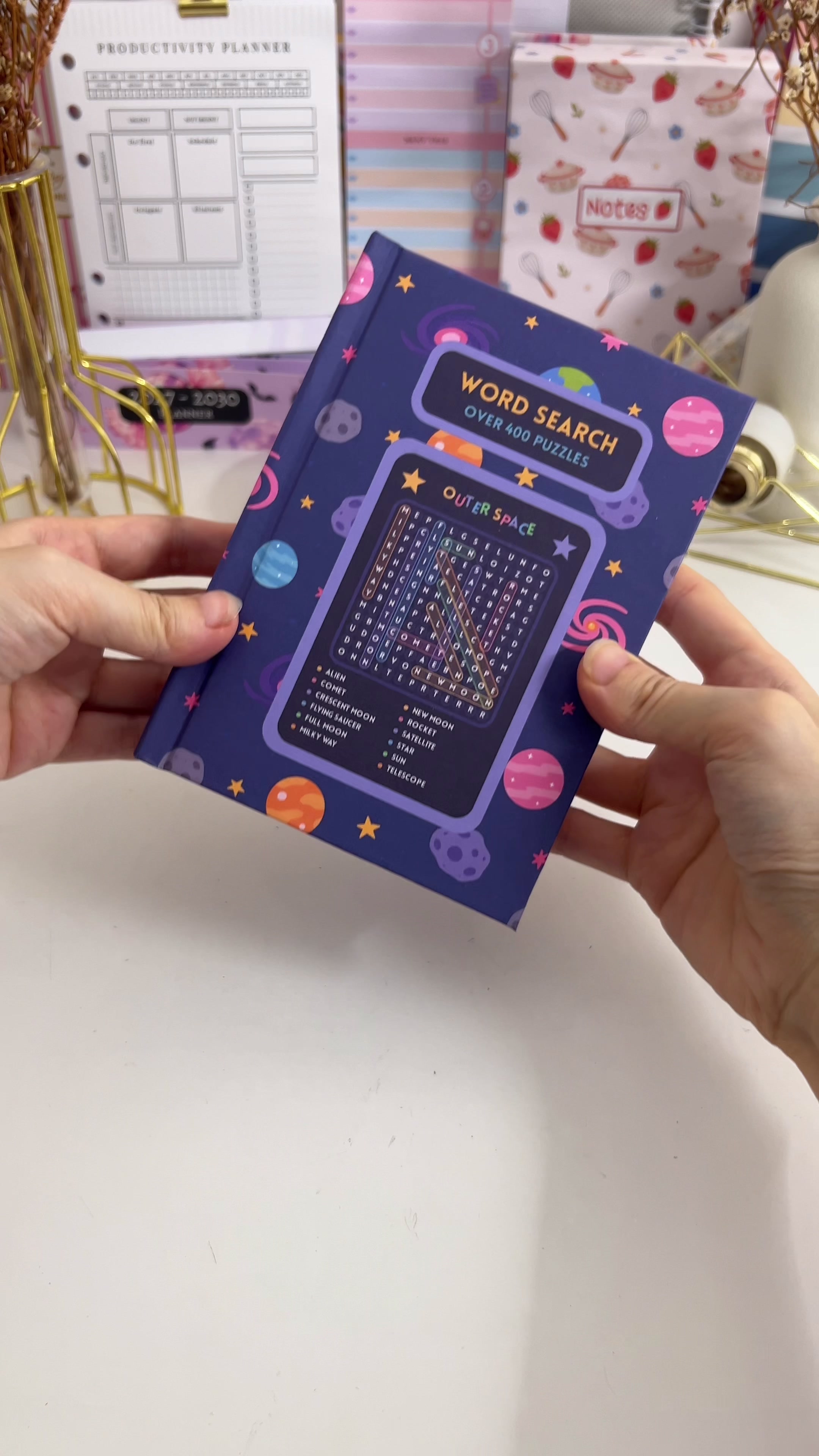 Finished hardbound word search puzzle book opened to show a puzzle page