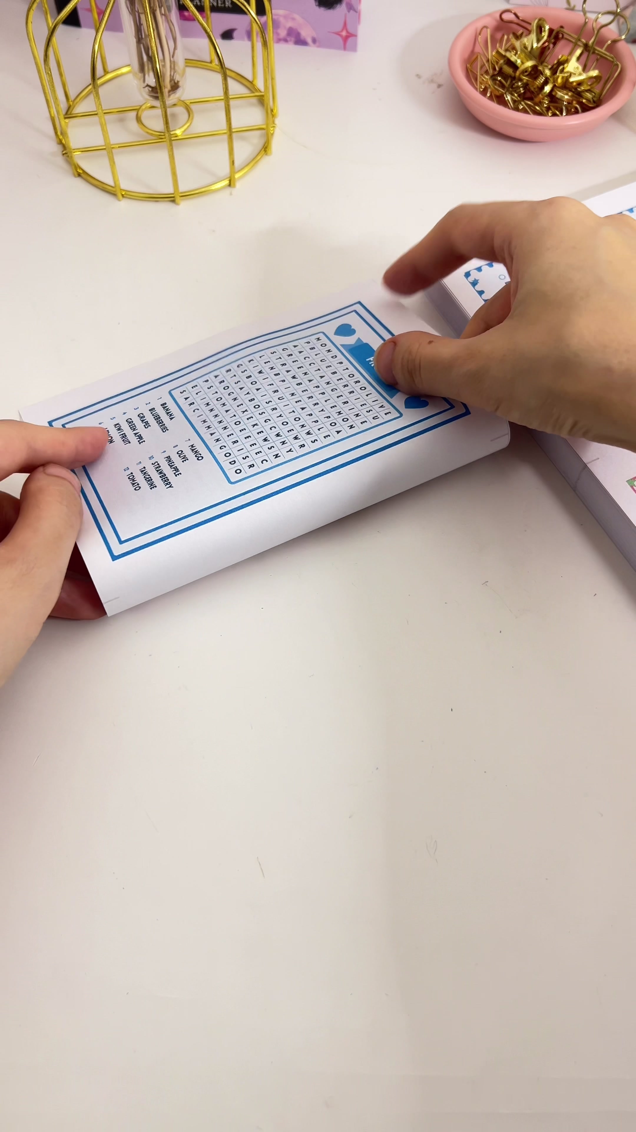 Folding a printed word search sheet in half
