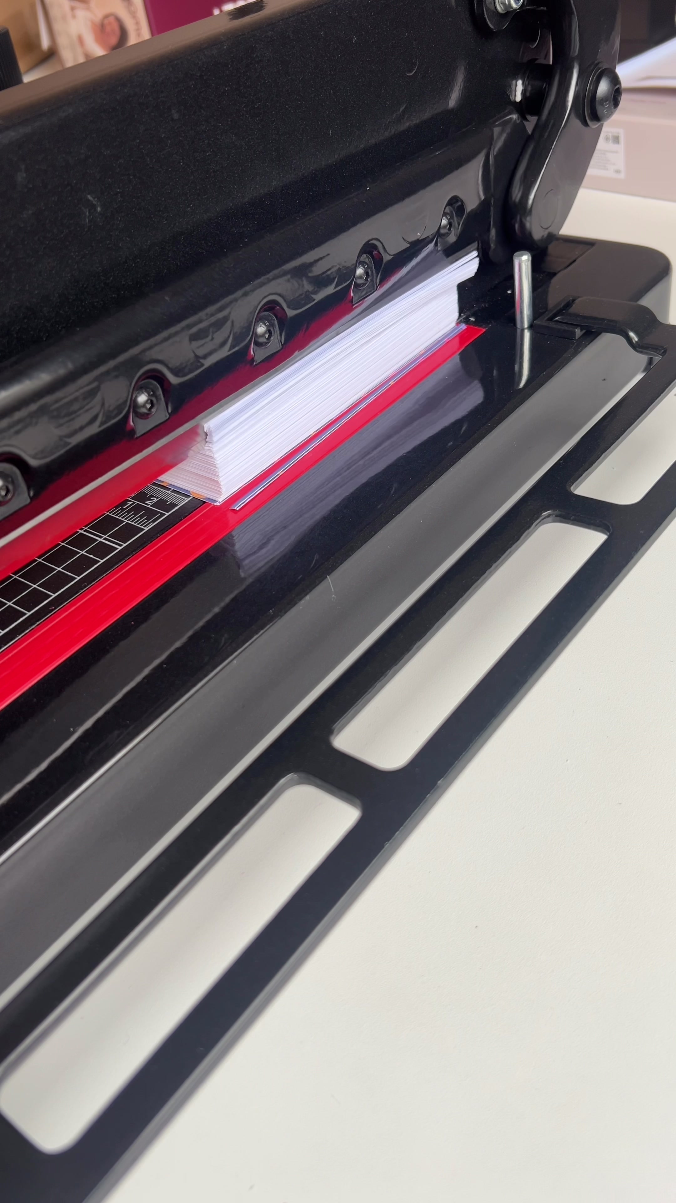 Trimming the white edges from printed word search pages on a guillotine cutter