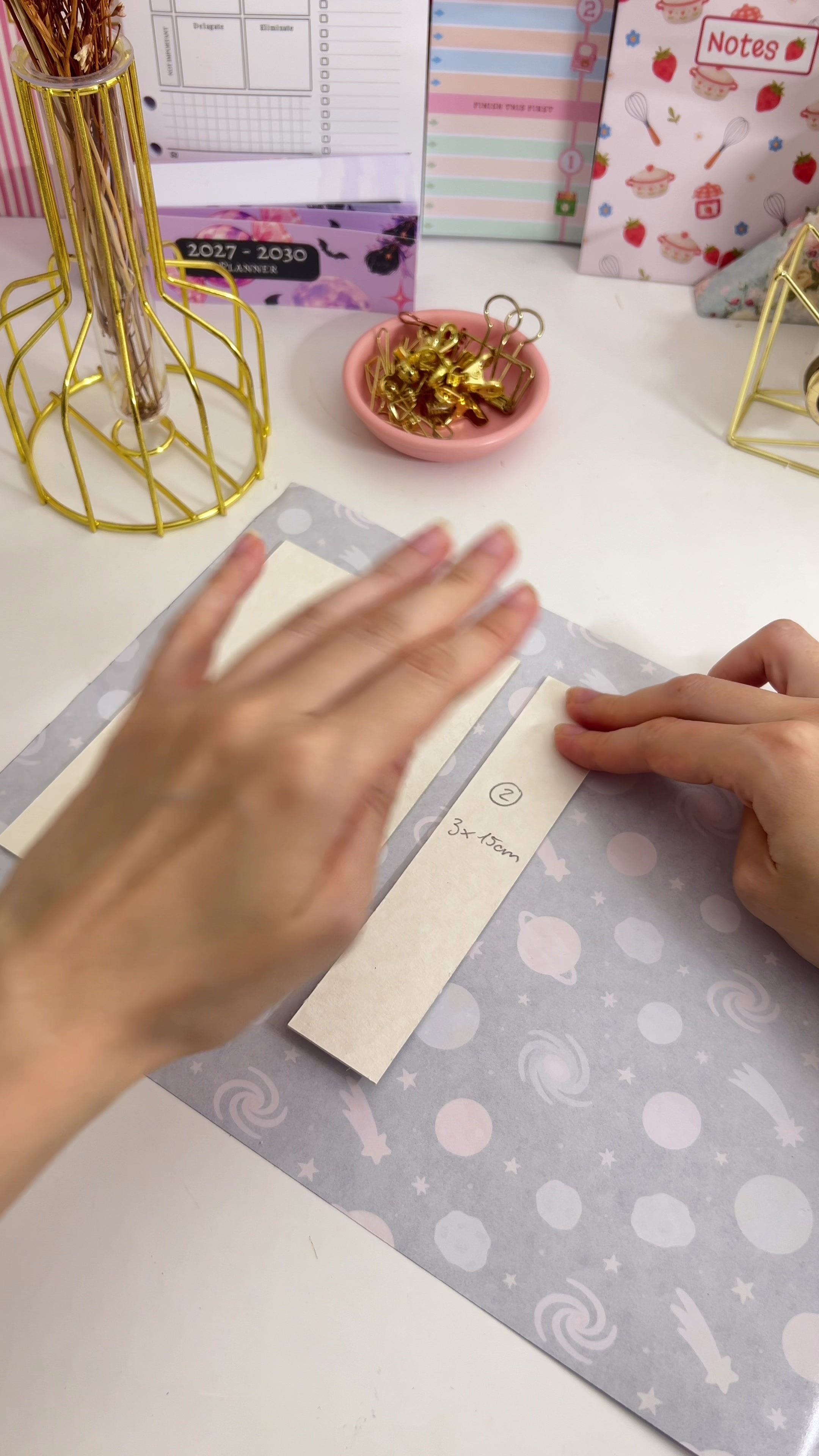 Three chipboard pieces placed on the printed cover paper with gaps between them